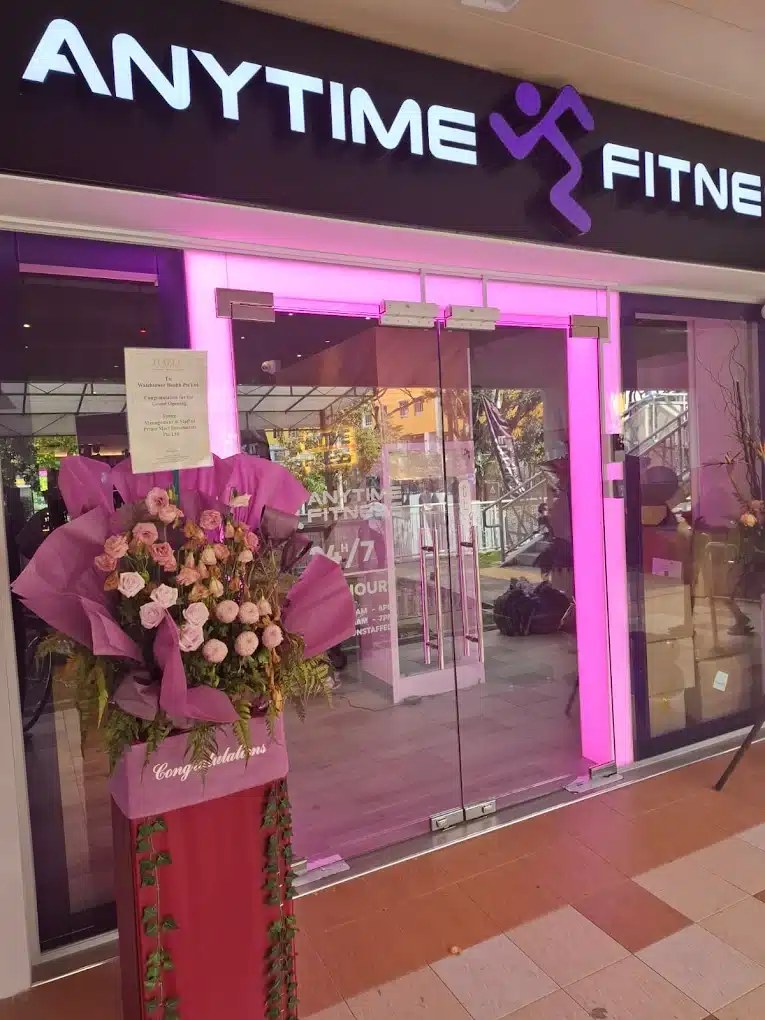 Entrance of Anytime Fitness Yishun East run by the ReFormd Group during opening with congratulation bouquet of flowers outside the unit