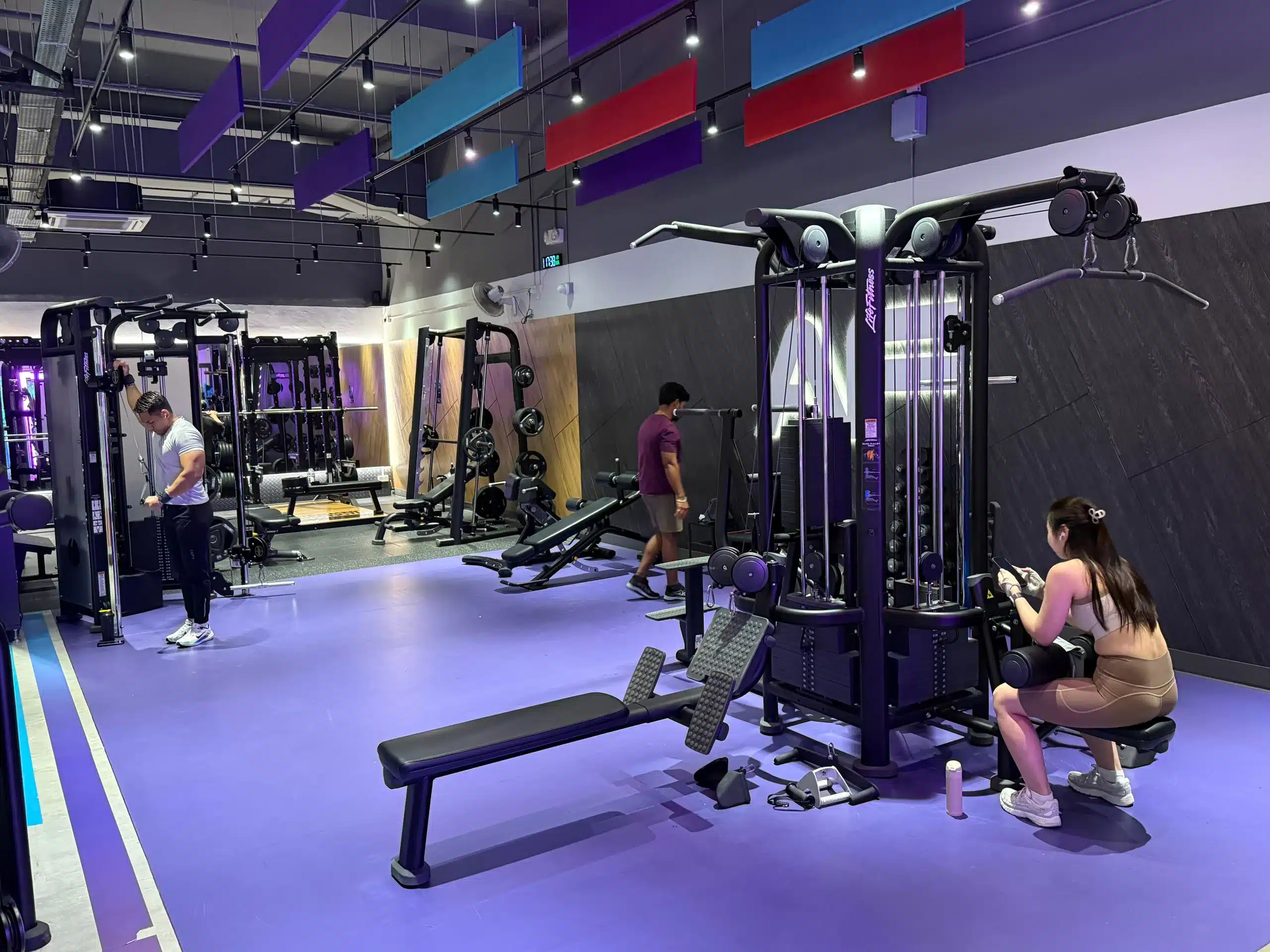 A four point jungle cable set up in Anytime Fitness Yishun East. Machines are brand new and clean. There are people training in the gym with different cables.