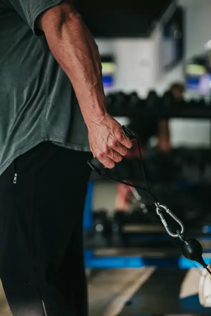 Man holding a cable D handle during an exercise